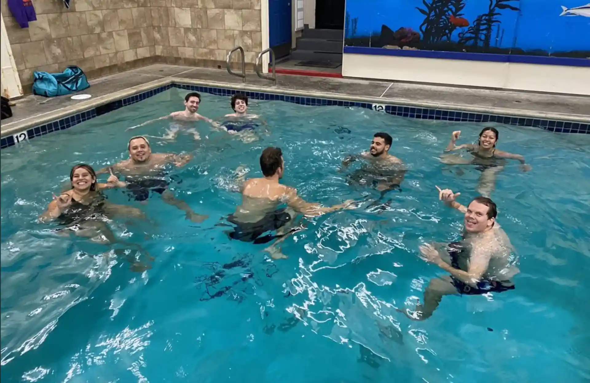 NEW PADI STUDENT SCUBA DIVERS IN ON-SITE POOL AT DIVE SHOP