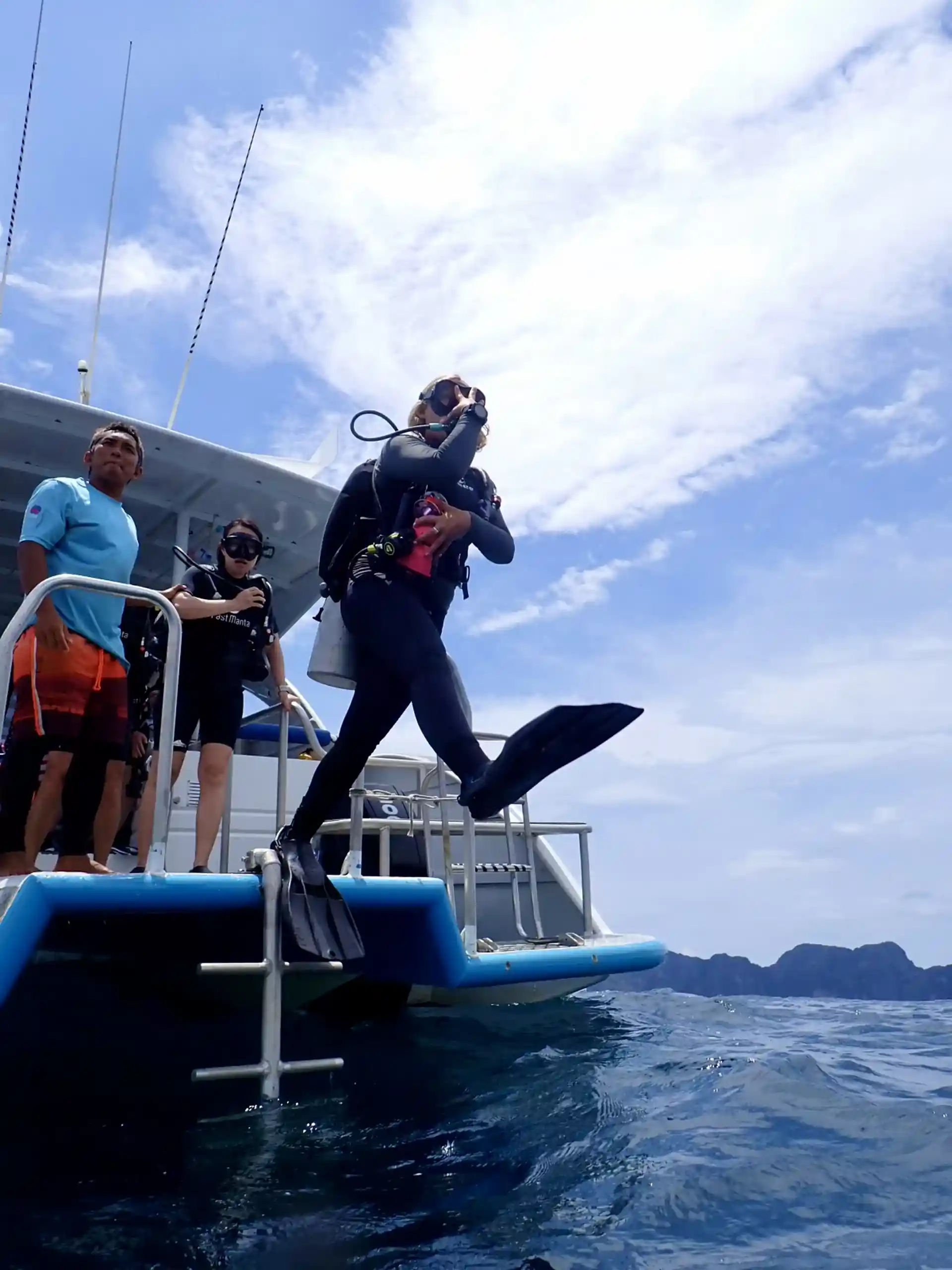 Diver entering the water with a giant stride.