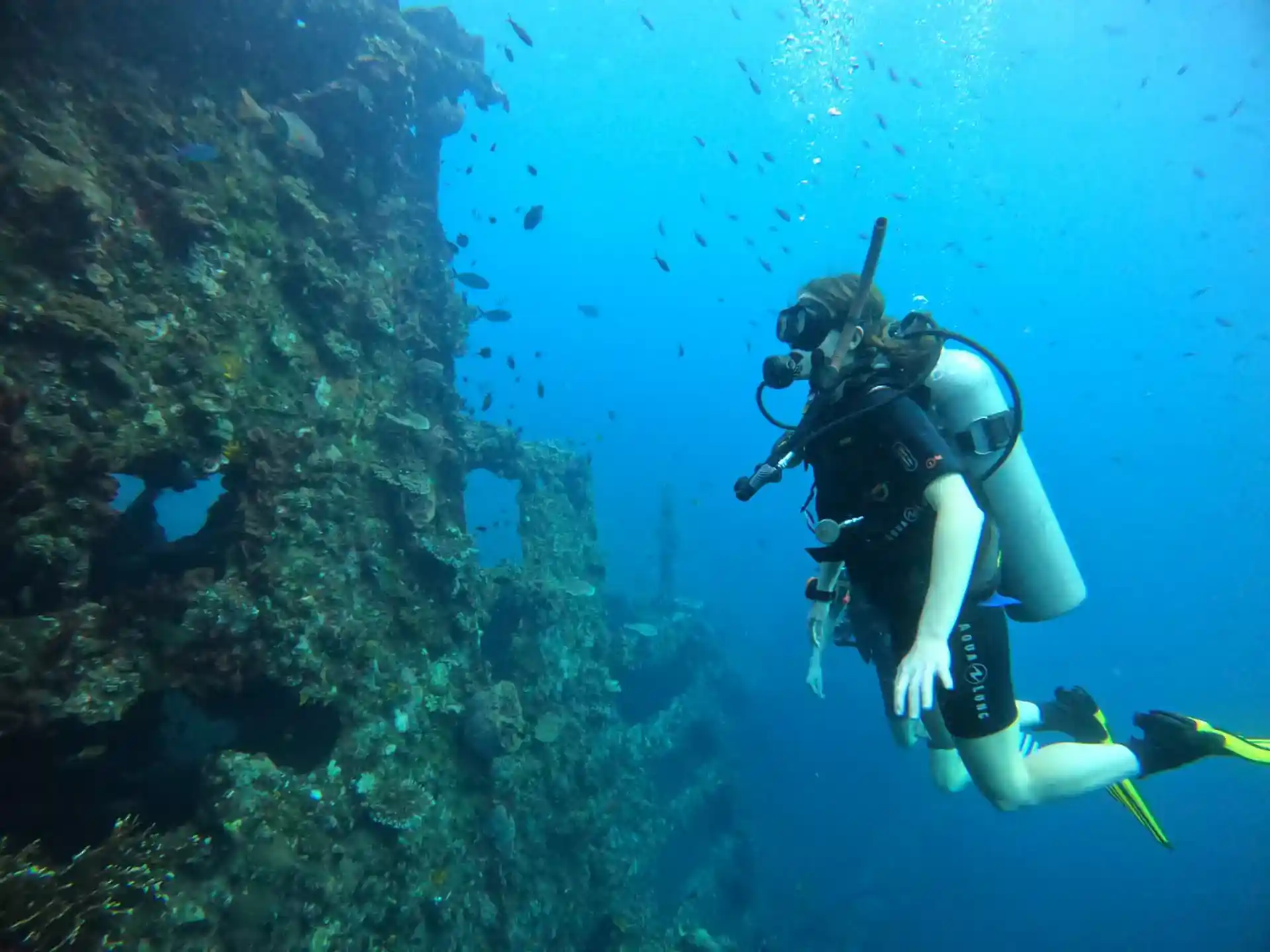 A diver next to the famous USAT Liberty Wreck in Tulamben during a guided fun dive