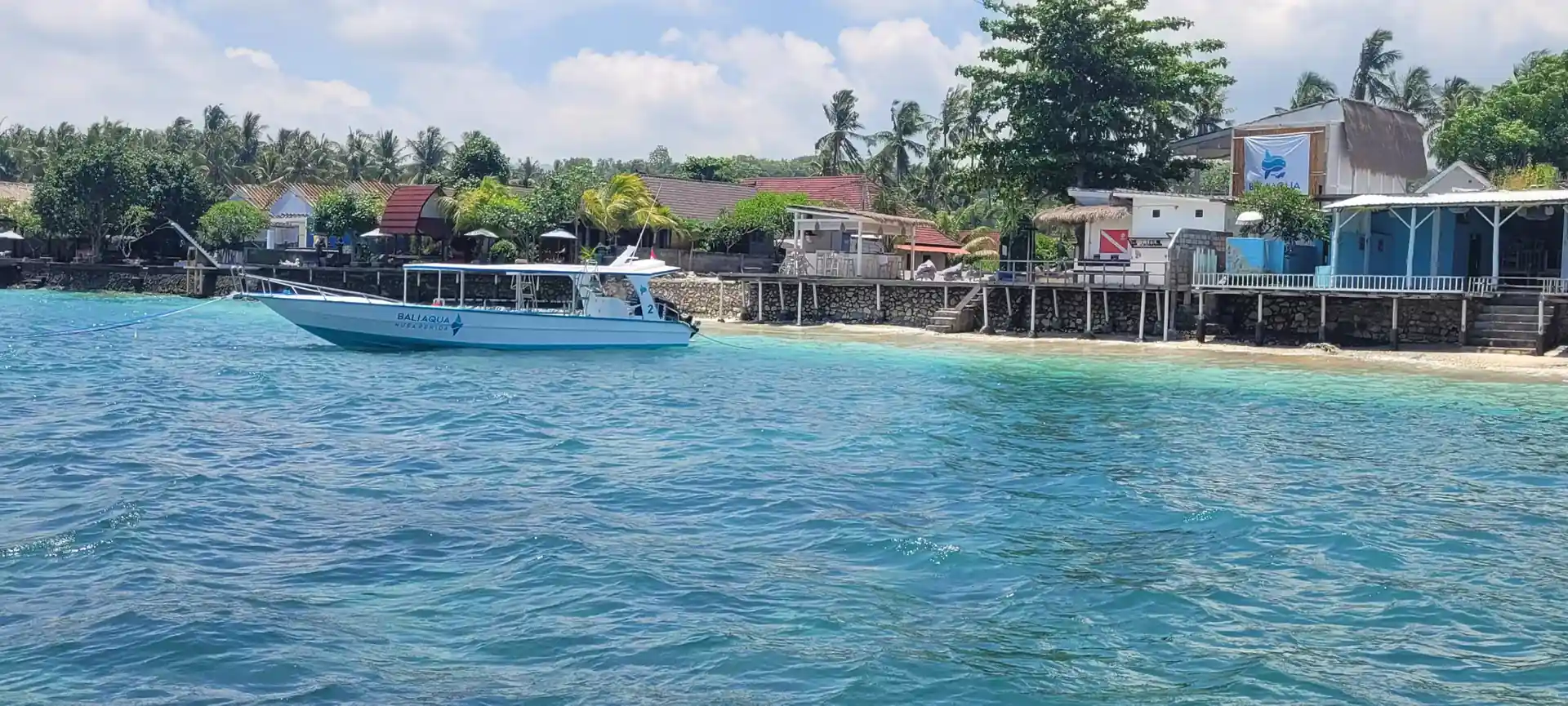 A view of our dive center and one of our boats from the ocean