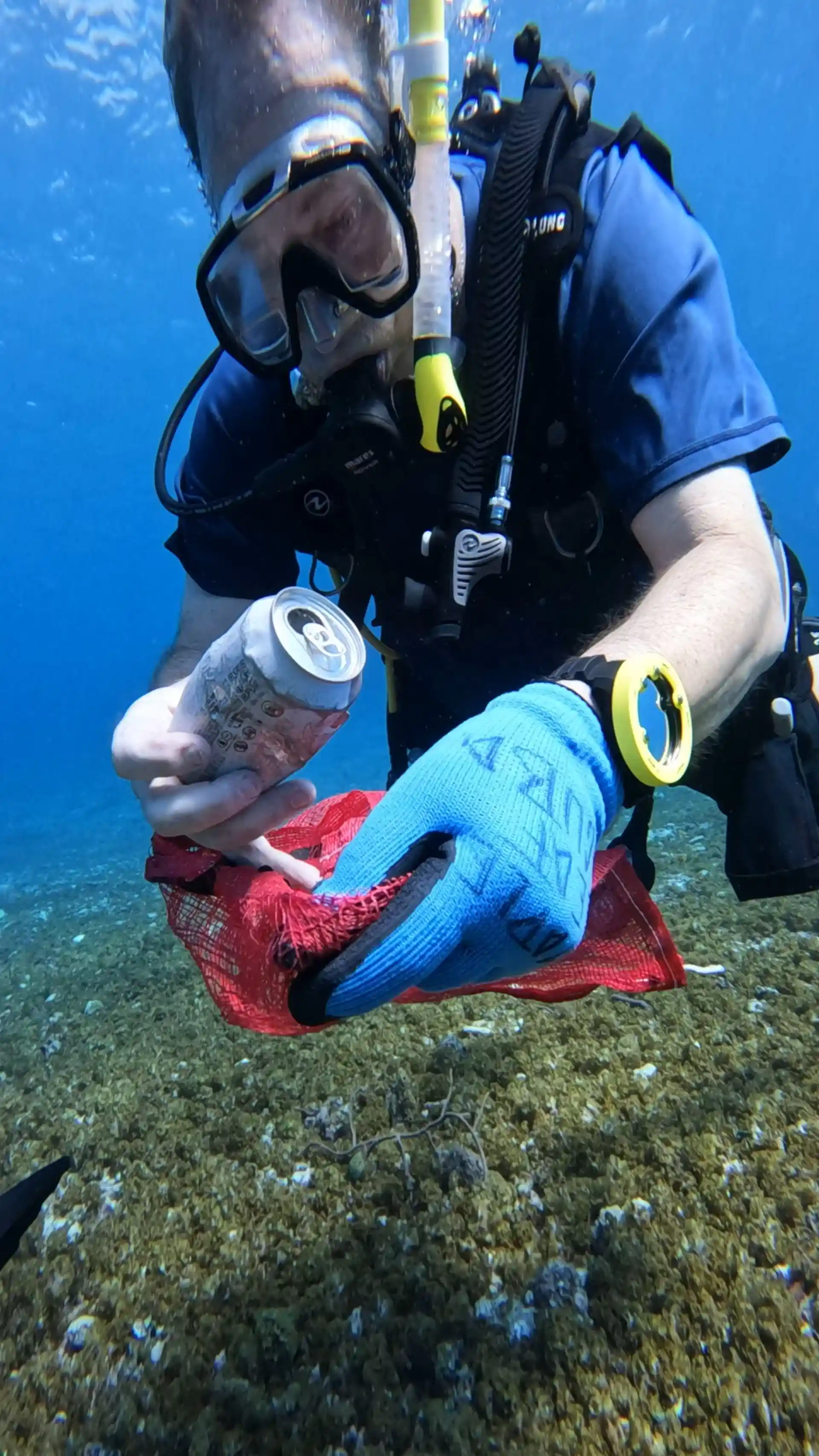 Volunteer diver removing trash from the ocean