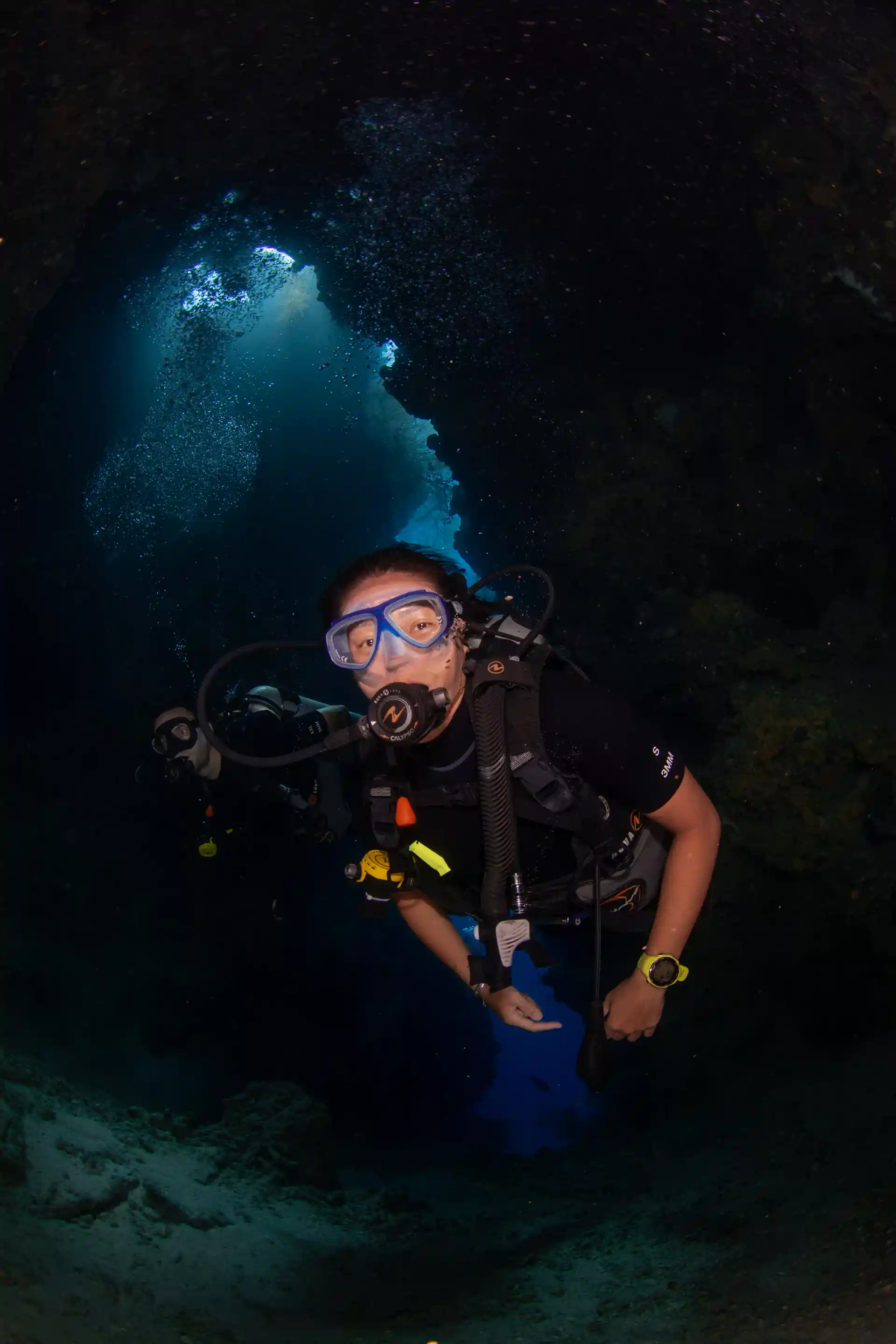 Entering a small cave with direct surface access as part of the adventure dive.