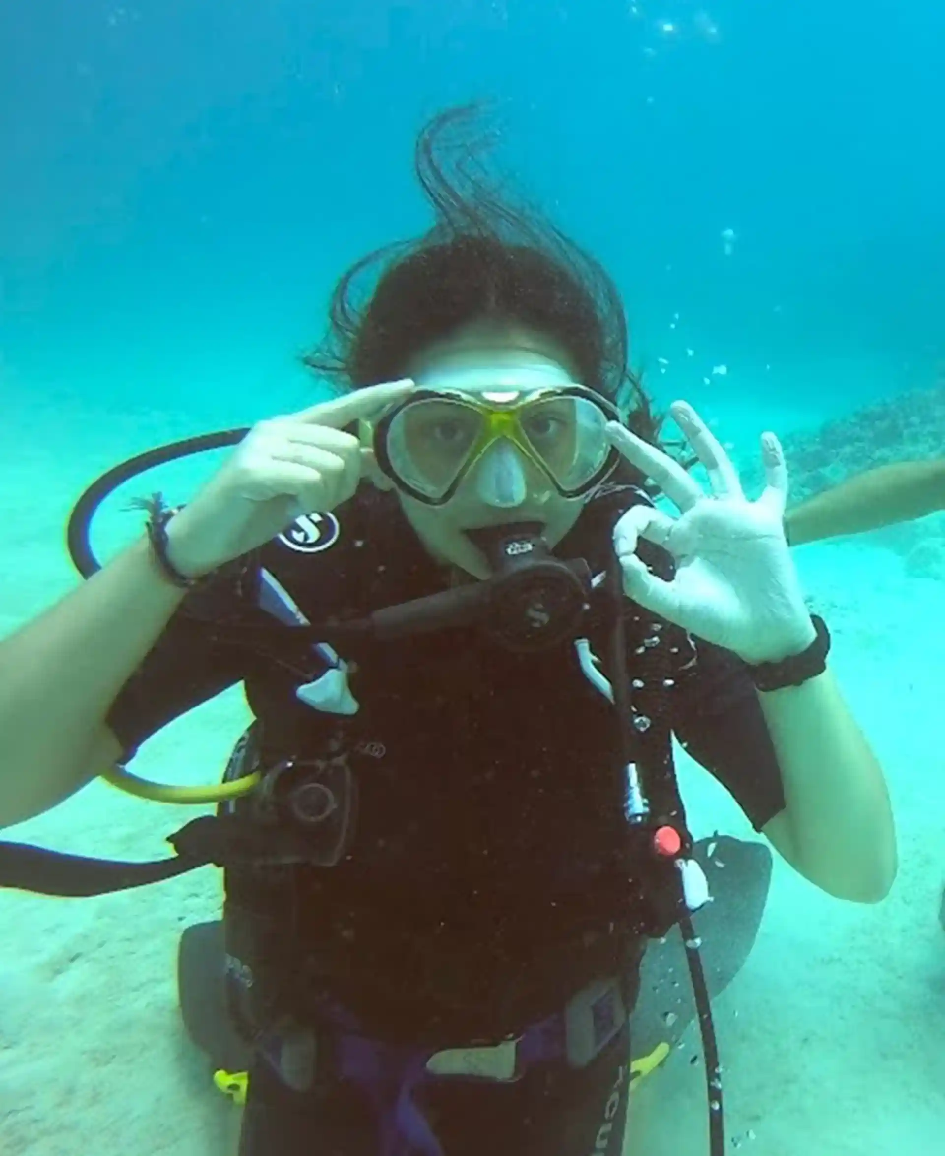 Beginner diver practising skills and signalling OK during a Discover Scuba Diving dive