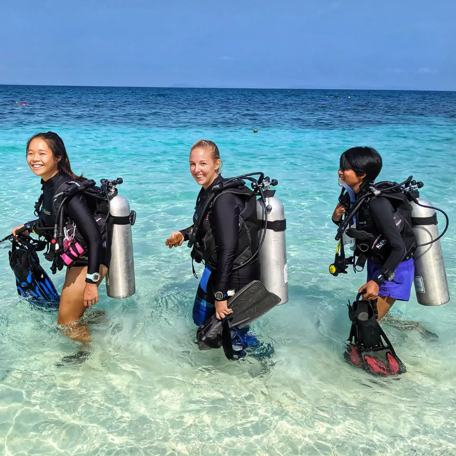 Instructor enters water with 2 students
