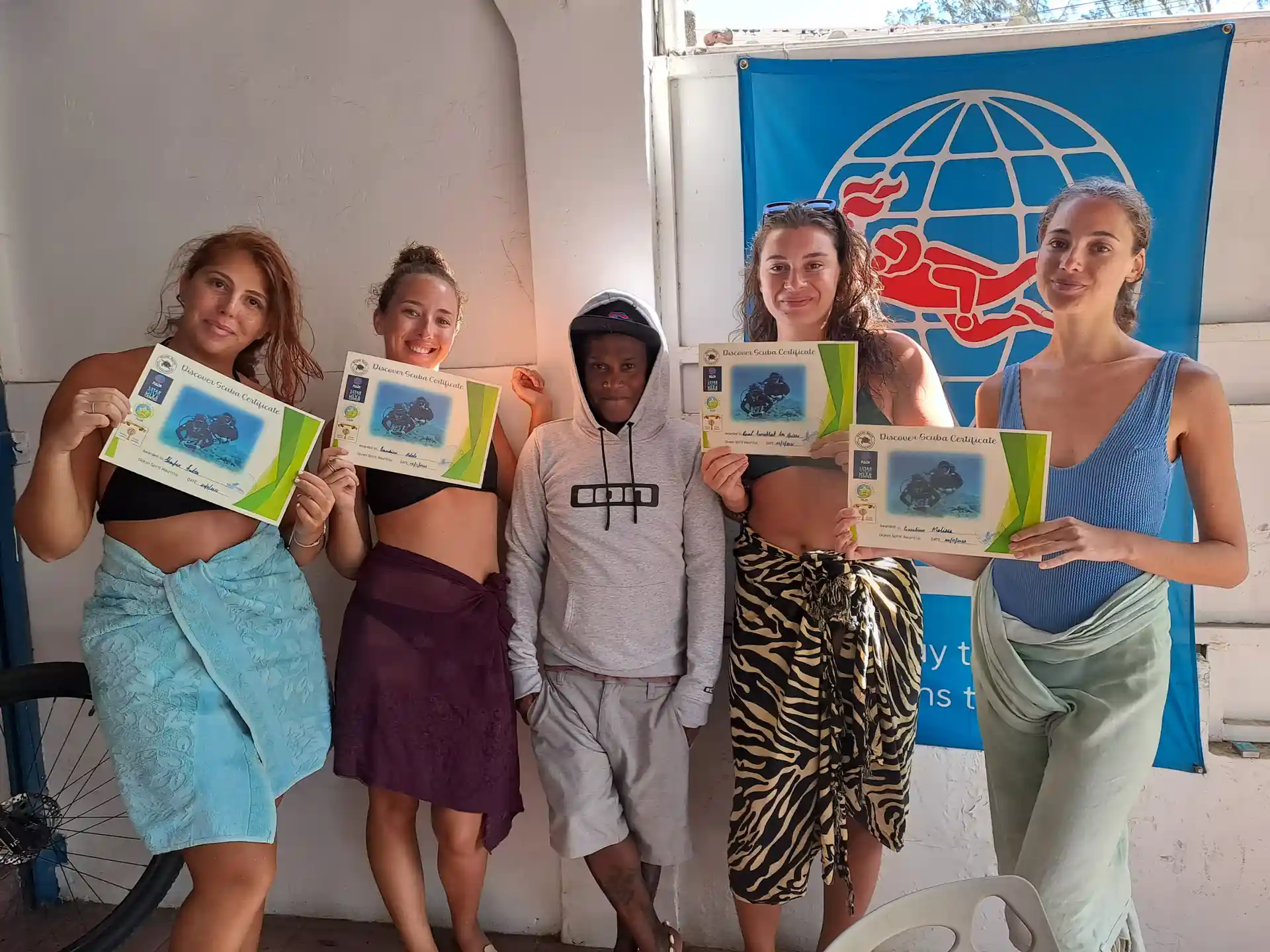 New divers celebrating after completing their PADI Discover Scuba Diving experience.