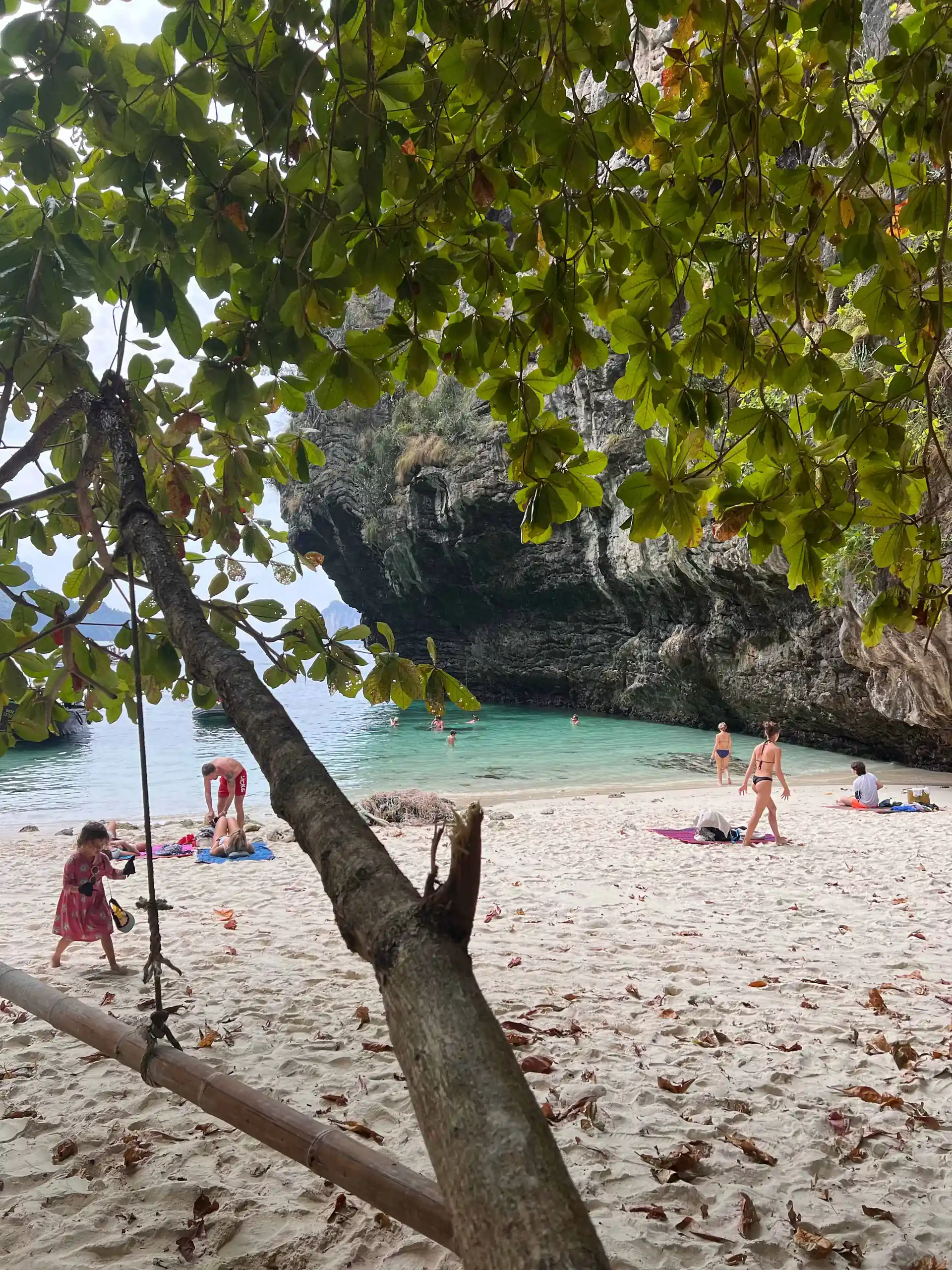 Crystal-clear waters meet a shoreline littered with trash.
