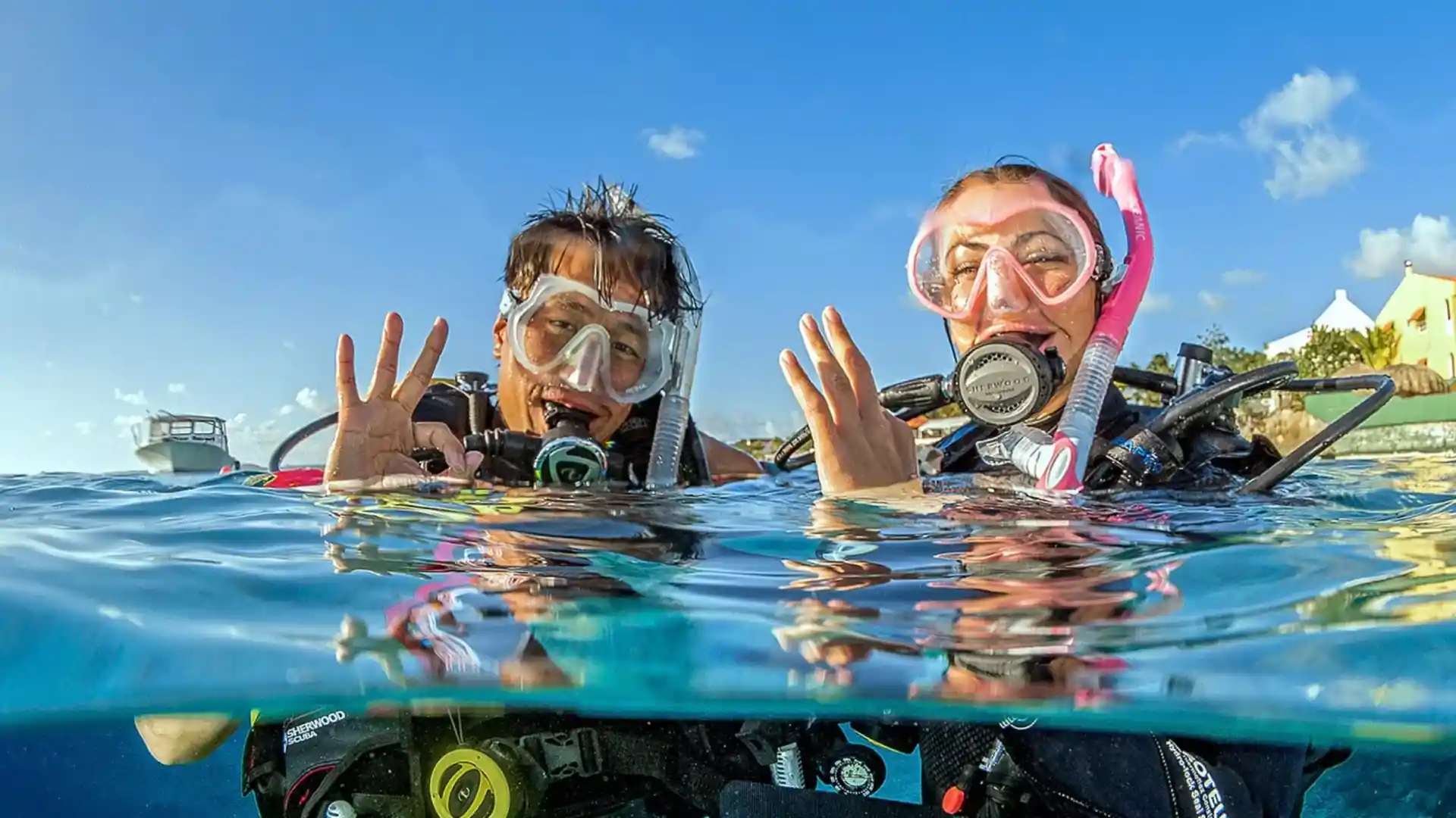 Experience the exhilaration of PADI SCUBA diving in Malapascua, Cebu, Philippines with Sea Explorers. Two divers surface, brimming with joy after an unforgettable exploration.