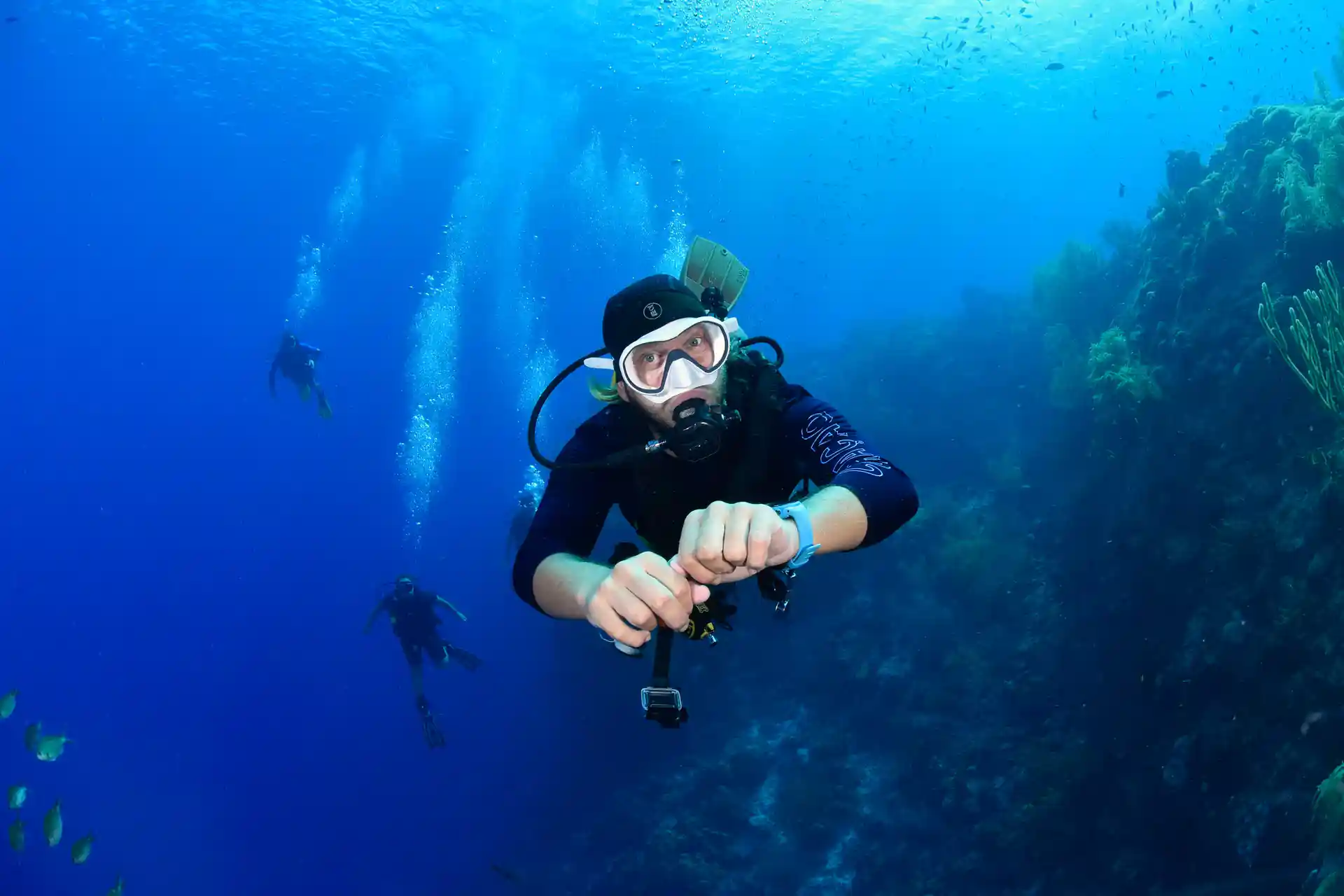 diver posing over the reef