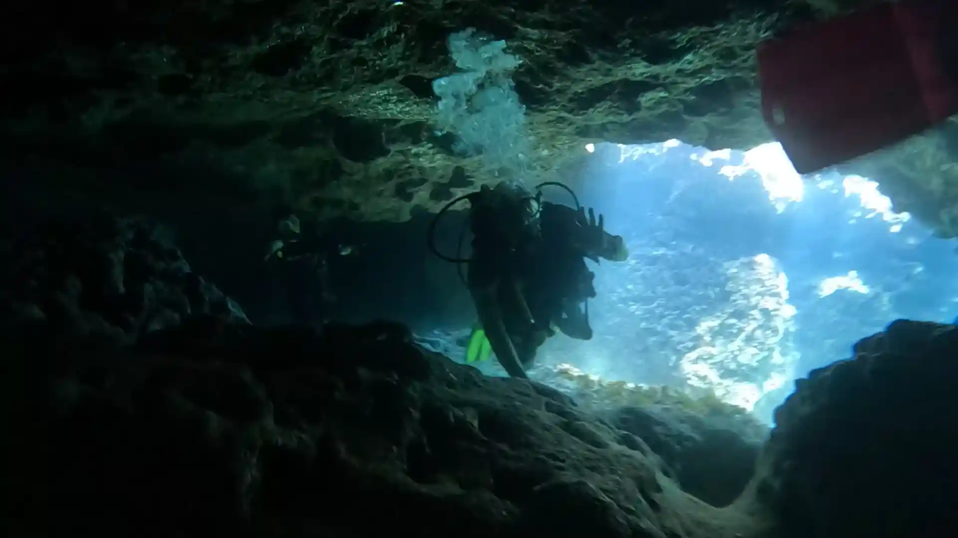 Diving through the cavern at Ghar Lapsi